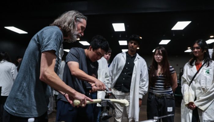 High schoolers, hand drills and bone saws